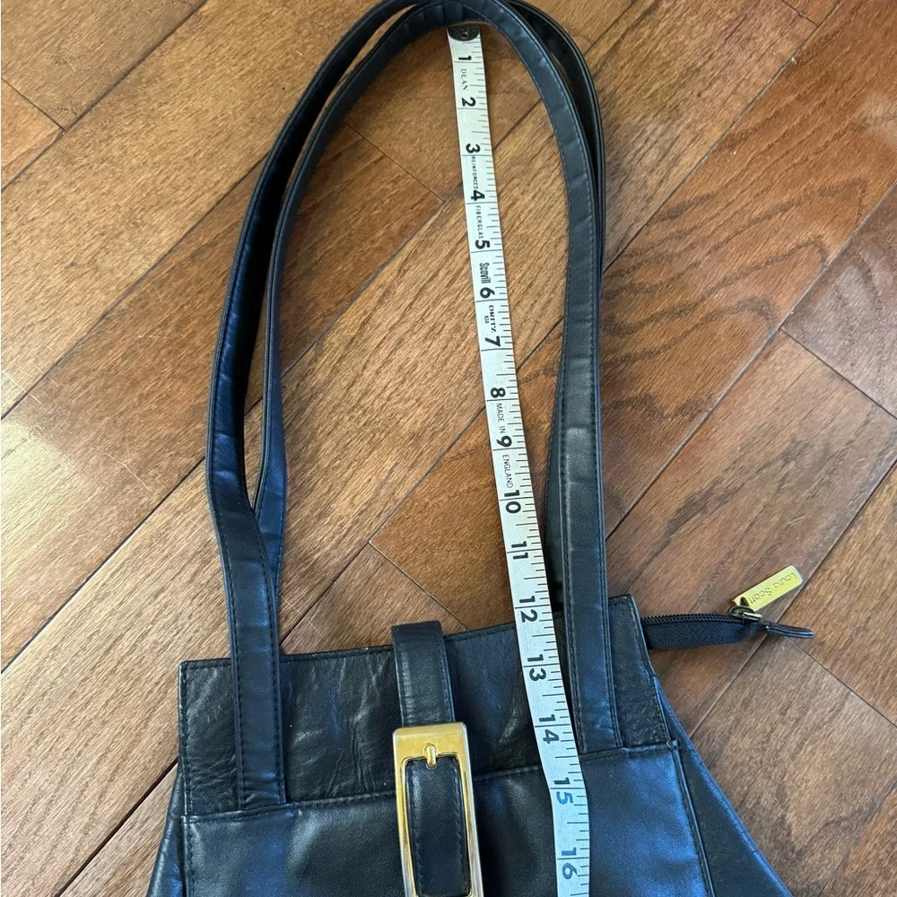 Laura Scott Black shoulder bag with front and back outer pockets, snap closure.